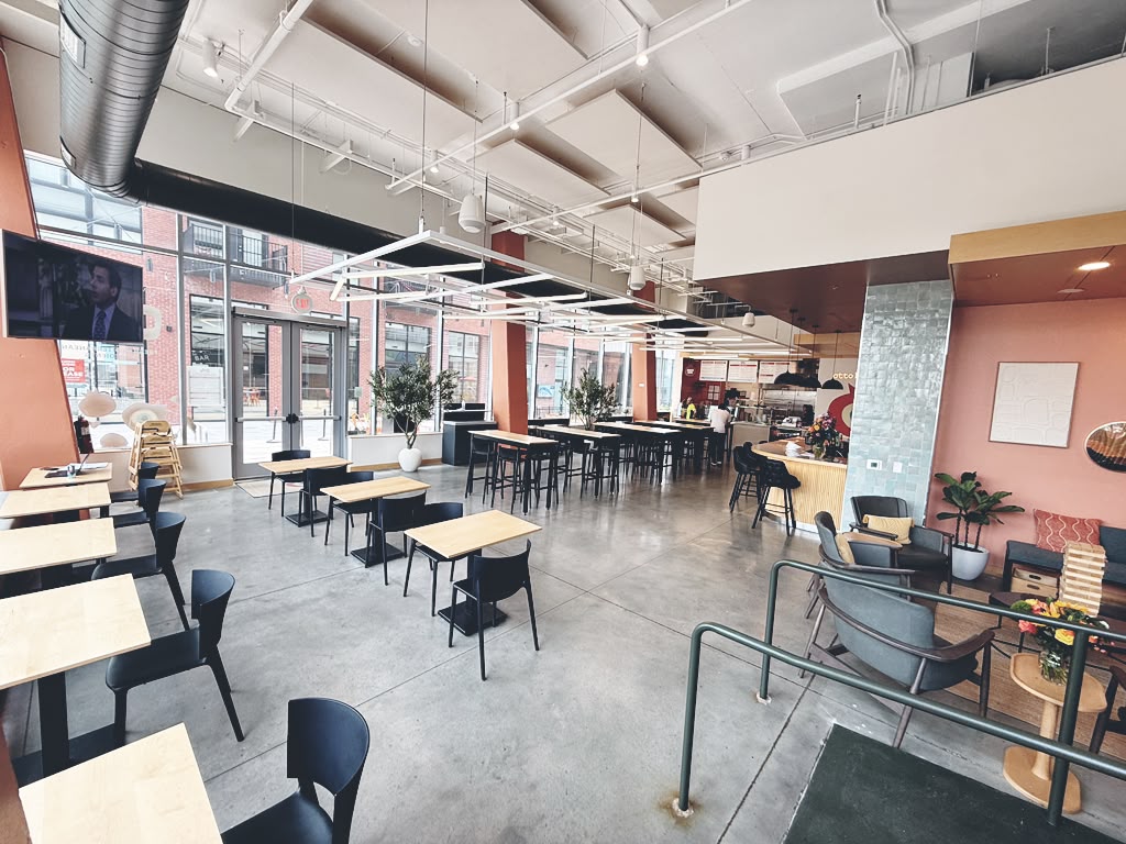 Otto Richmond's bright indoor dining room with high ceilings and big windows