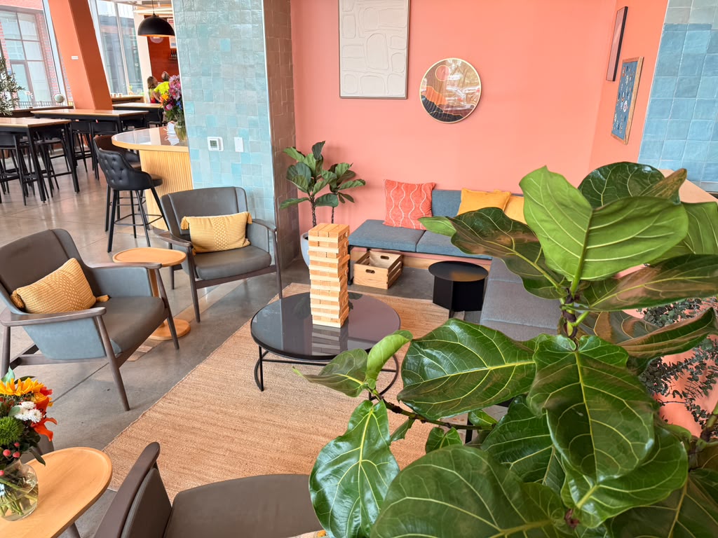Warm lounge area with soft seating and greenery at Otto Richmond
